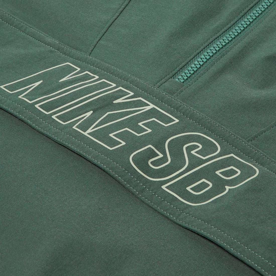 Close-up of vintage green Nike SB Anorak Skate Jacket with zip and logo detailing