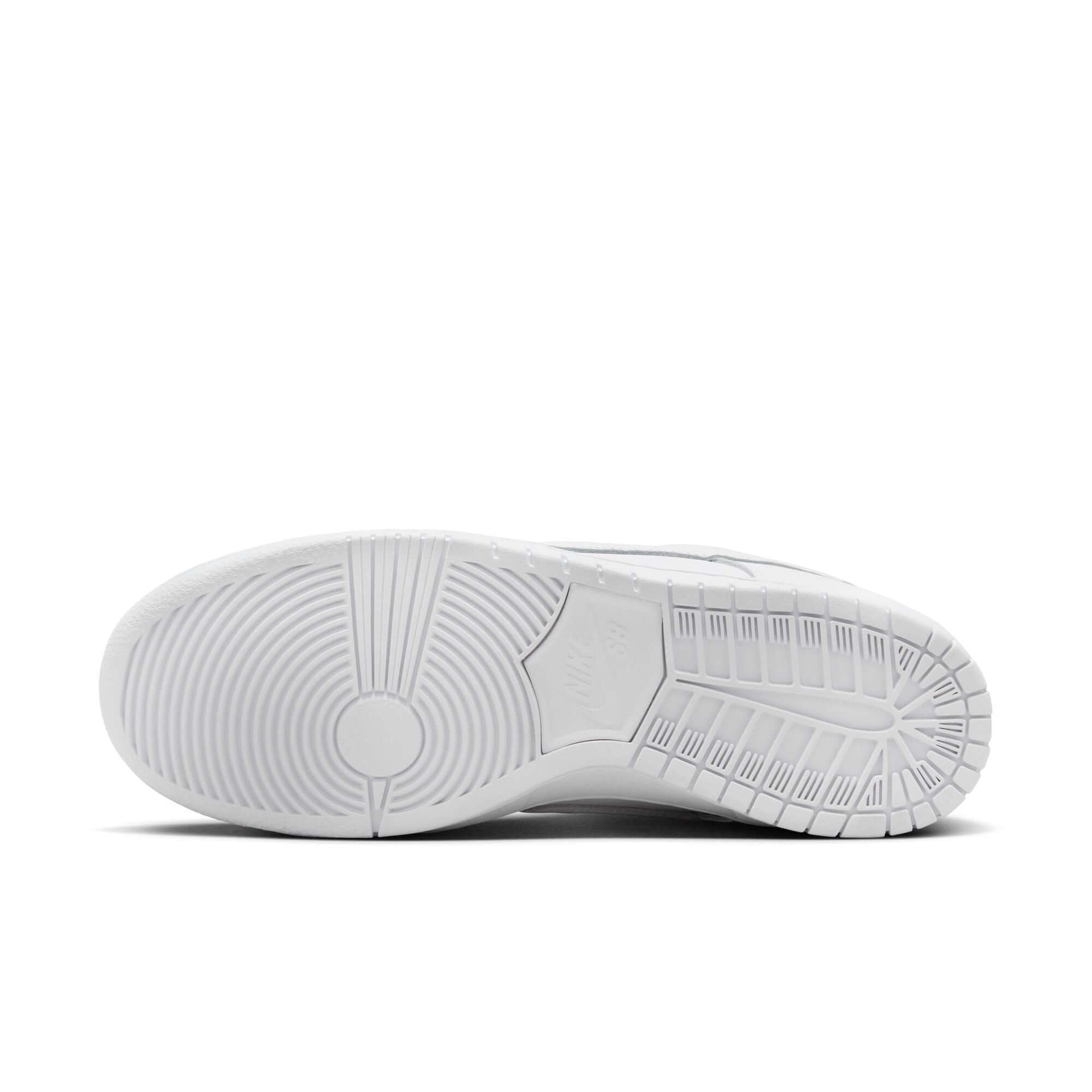 Nike SB Dunk Low Pro white shoe bottom view showcasing rubber outsole with classic hoops pivot circle for durable traction