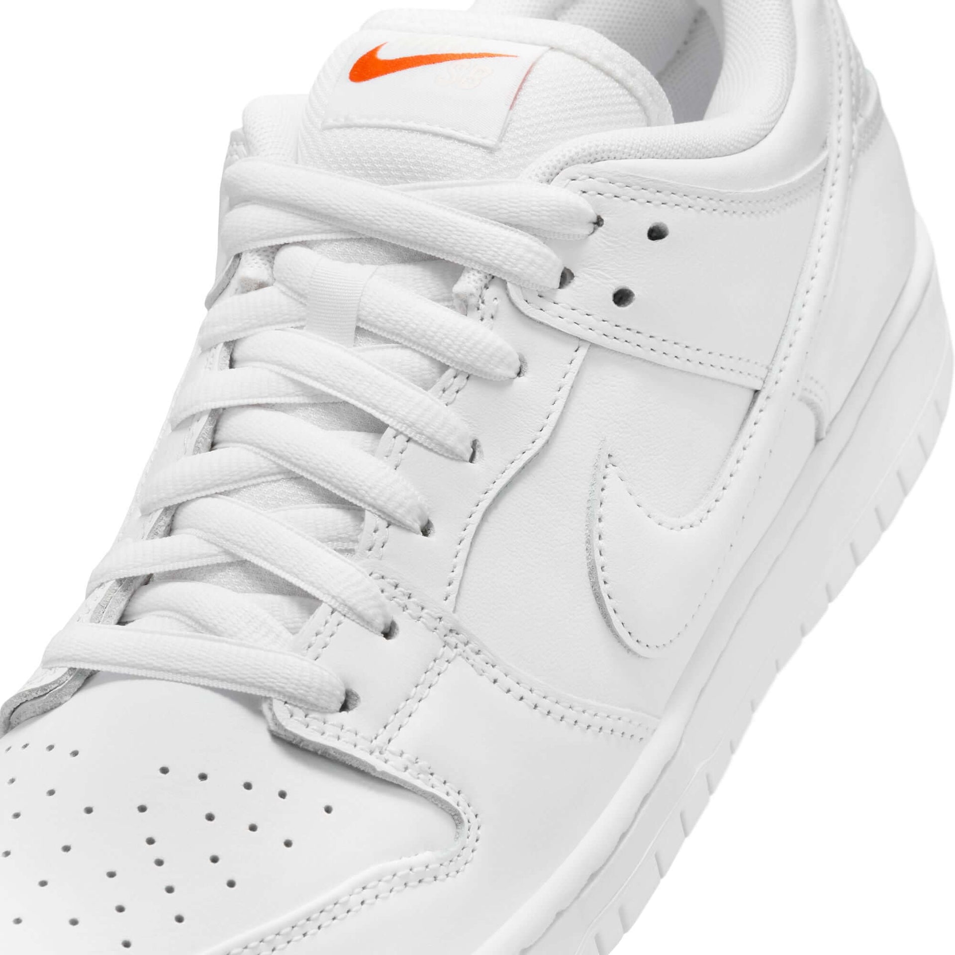 Nike SB Dunk Low Pro in white, showcasing premium leather upper, padded collar, and classic orange Swoosh.