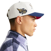 Person wearing a white Nike cap with a logo on a white background