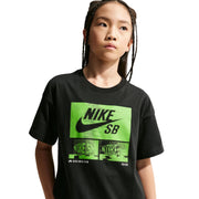 Child wearing a black Nike SB t-shirt with green logo on a light gray background