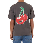 Person wearing a gray t-shirt with a cherry graphic on the back, standing against a white background.
