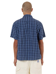 Person wearing a blue checkered shirt on a white background