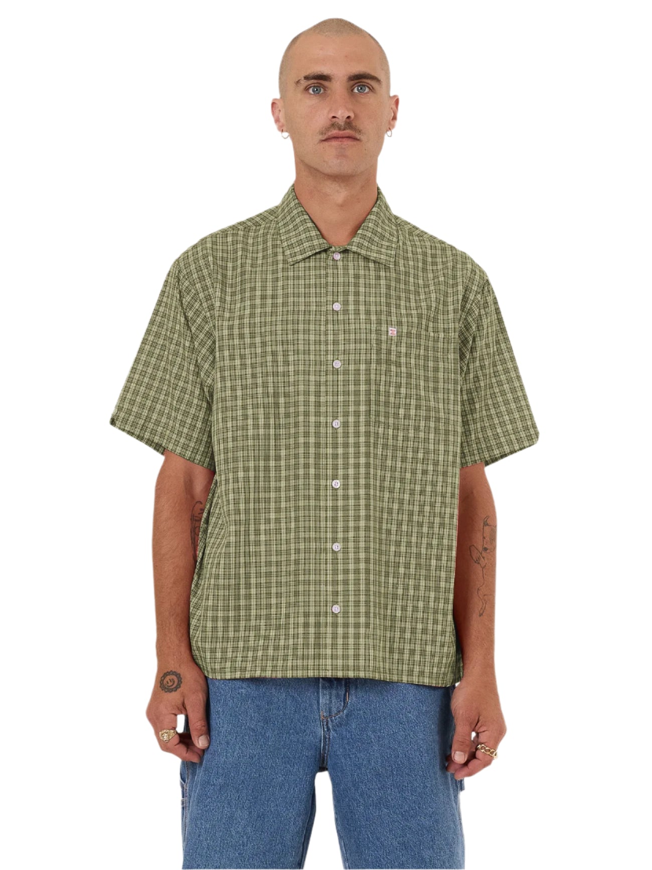 Man wearing a green checkered shirt and blue jeans on a white background