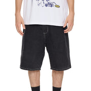 Person wearing black denim shorts on a white background