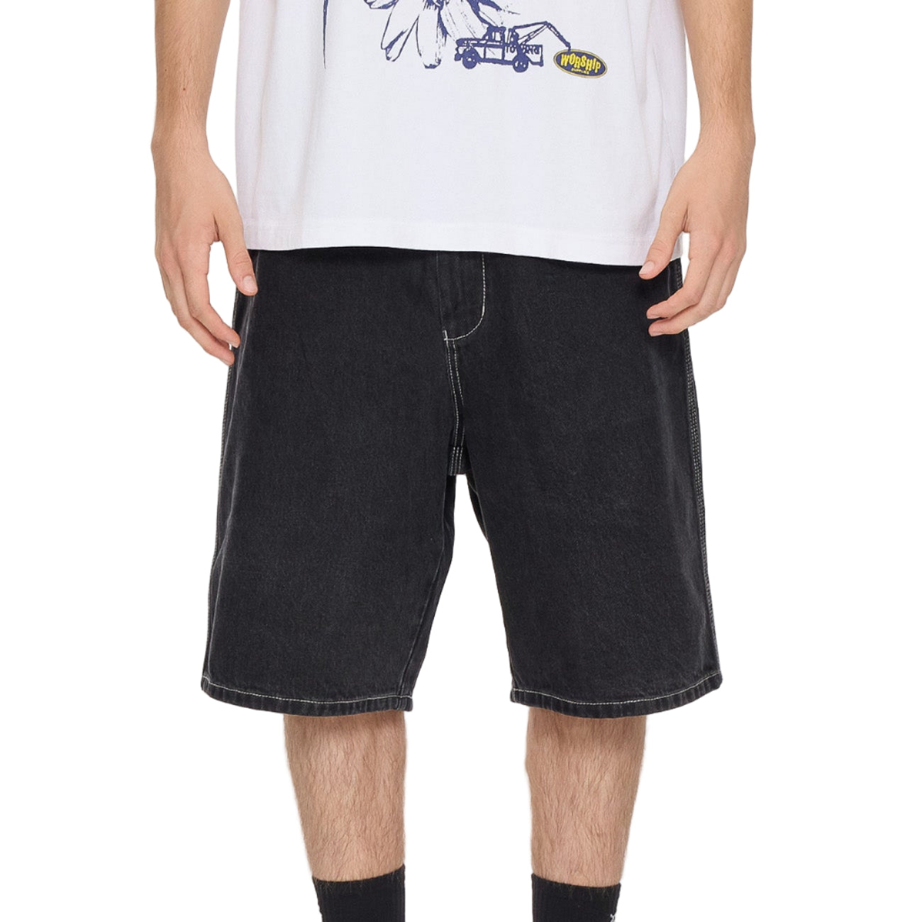 Person wearing black denim shorts on a white background