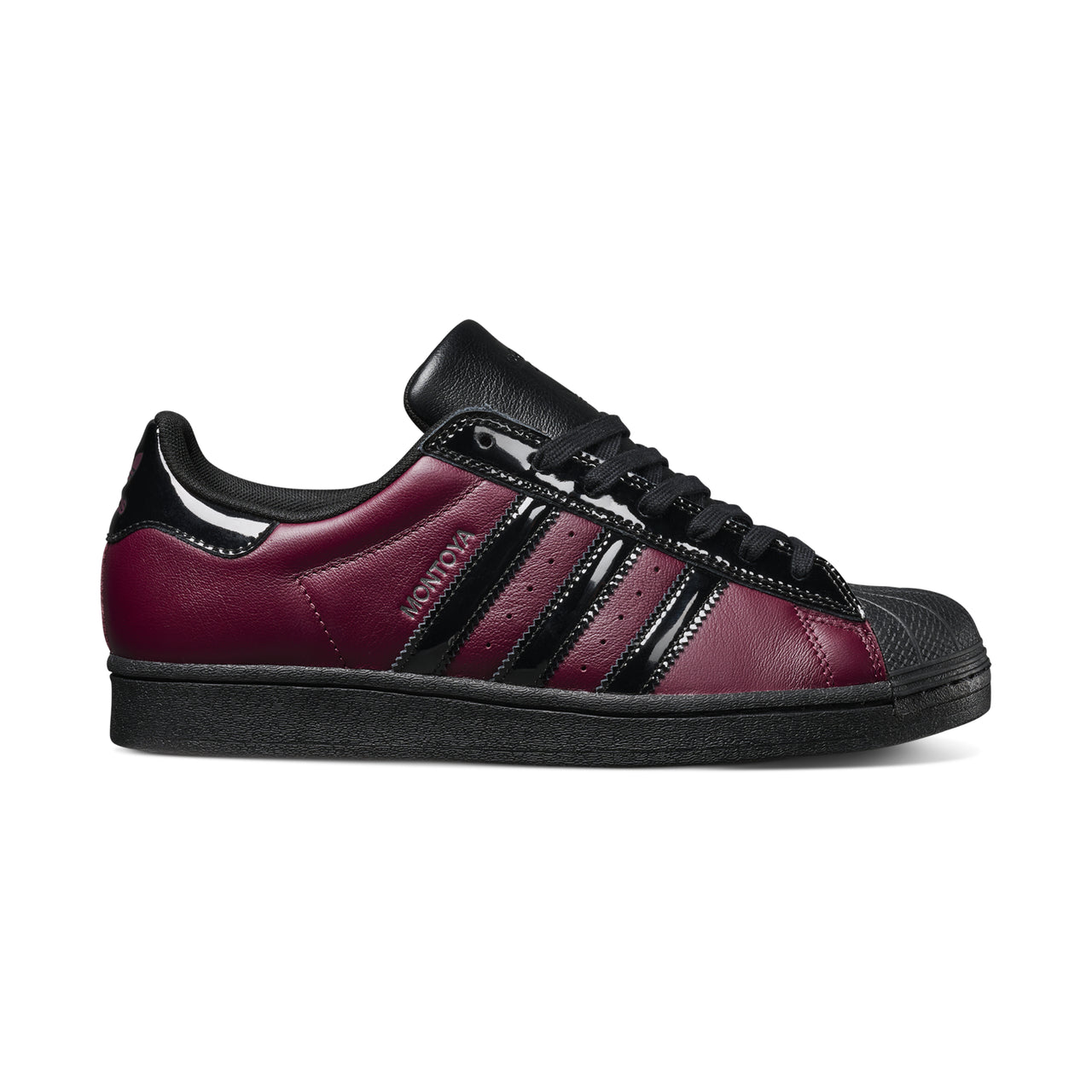Maroon and black Adidas sneaker on a white background