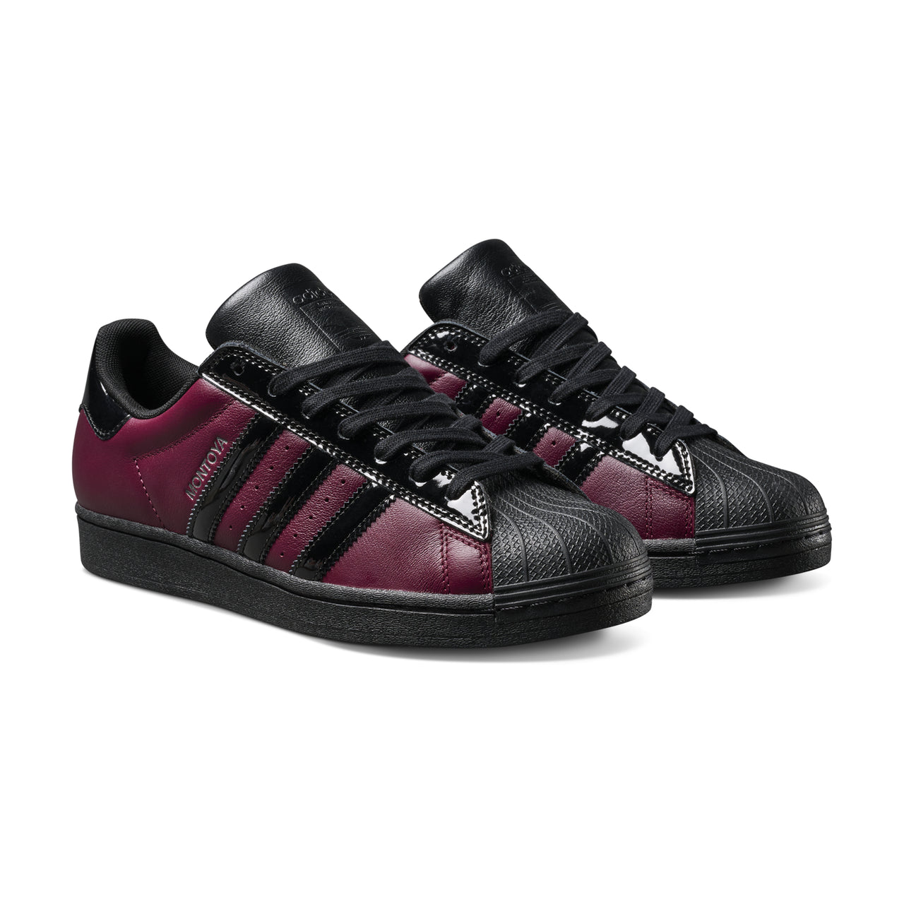 Black and red sneakers with three stripes on a white background